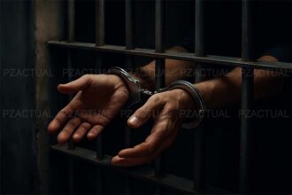 Imagen muestra manos con esposas en cárcel